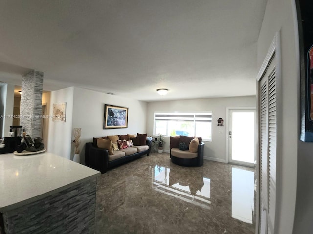 living room with marble finish floor and baseboards