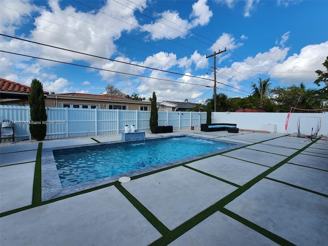 view of swimming pool with a fenced backyard, a fenced in pool, and a patio