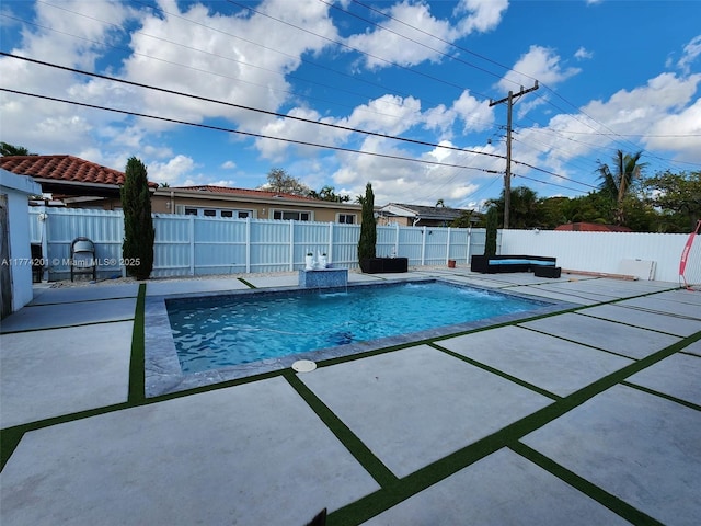 view of swimming pool featuring a fenced backyard, a fenced in pool, and a patio area