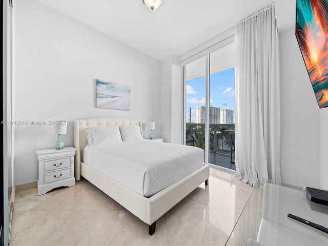15901 Collins Ave Unit 405, Sunny Isles Beach, FL 33160 - bedroom featuring light marble finish flooring, access to outside, expansive windows, and baseboards