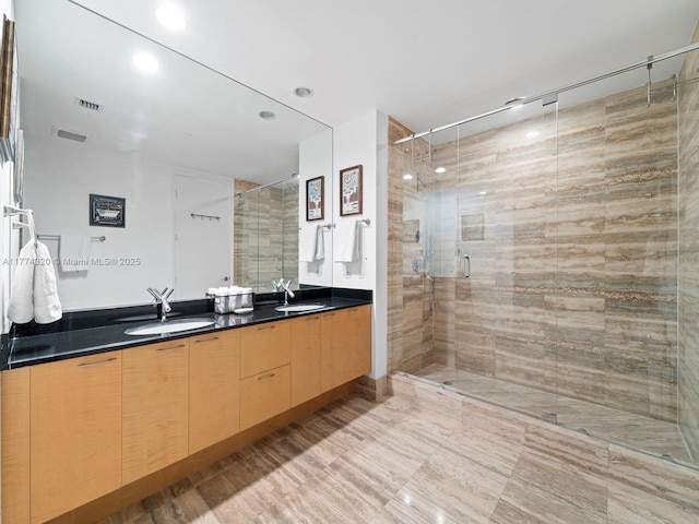 15901 Collins Ave Unit 405, Sunny Isles Beach, FL 33160 - bathroom featuring a shower stall, double vanity, and recessed lighting