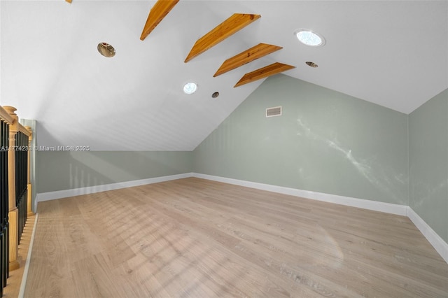 bonus room featuring light wood-style floors and baseboards