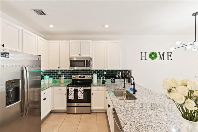 23300 SW 110th Ct, Homestead, FL 33032 - kitchen with light tile patterned floors, visible vents, a sink, decorative backsplash, and appliances with stainless steel finishes