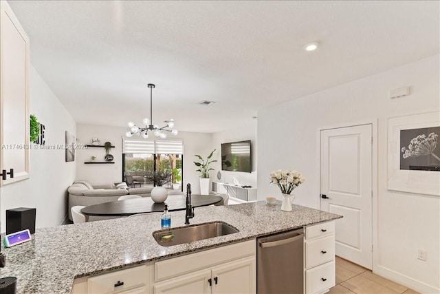 23300 SW 110th Ct, Homestead, FL 33032 - kitchen with a sink, light stone counters, an inviting chandelier, open floor plan, and stainless steel dishwasher