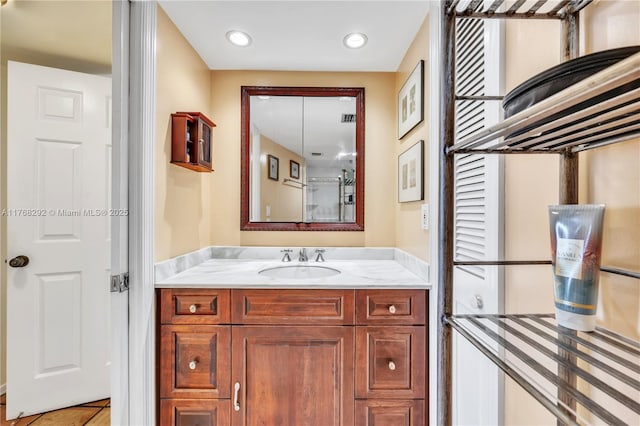 bathroom with tile patterned flooring, vanity, and recessed lighting