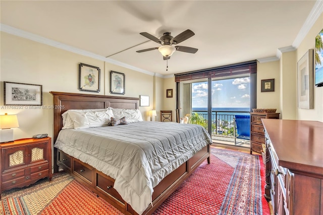 bedroom featuring a ceiling fan, ornamental molding, and access to exterior