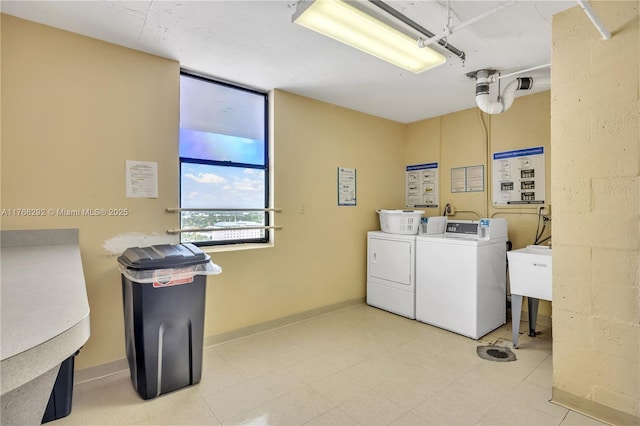 shared laundry area with independent washer and dryer