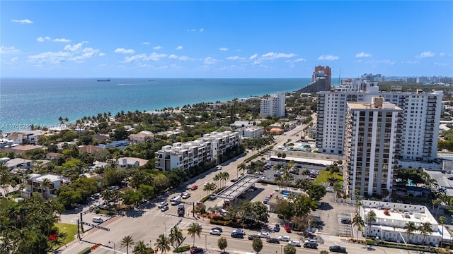birds eye view of property featuring a water view and a view of city