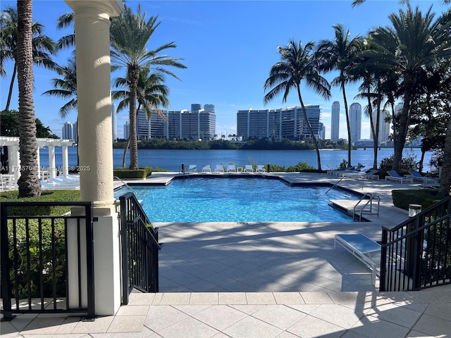 community pool featuring a water view and a patio area