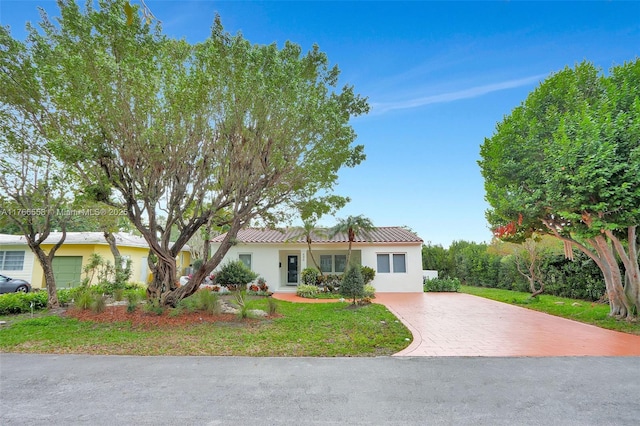 view of front of property with a front lawn, stucco siding, and driveway