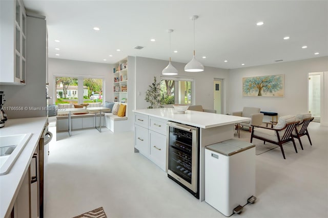 kitchen featuring beverage cooler, open floor plan, fridge, and recessed lighting