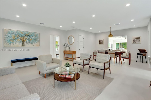 living room with visible vents, recessed lighting, and baseboards