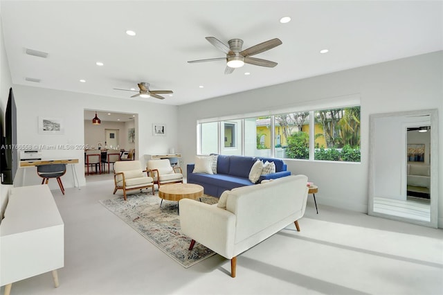 living room featuring visible vents, recessed lighting, ceiling fan, and concrete floors