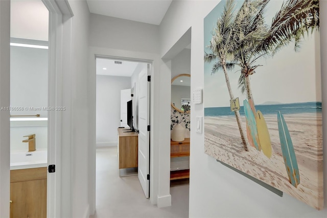 646 NE 114th St, Biscayne Park, FL 33161 - corridor featuring a sink and concrete floors