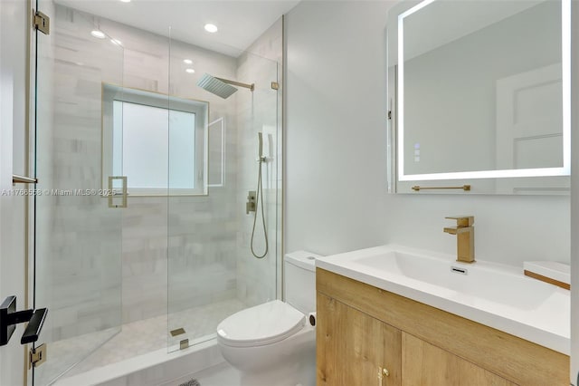 bathroom with recessed lighting, a shower stall, toilet, and vanity