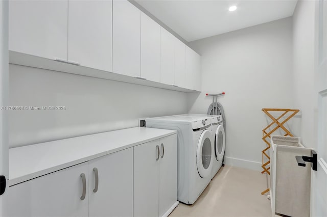 washroom with recessed lighting, cabinet space, washing machine and clothes dryer, and baseboards