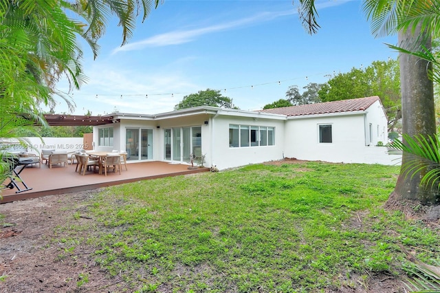 646 NE 114th St, Biscayne Park, FL 33161 - rear view of house with stucco siding, a yard, and a patio area