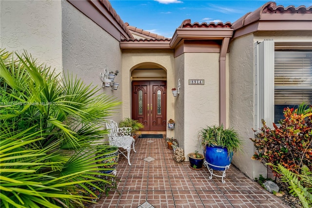 8914 SW 5th Ln, Miami, FL 33174 - view of exterior entry featuring stucco siding and a tiled roof