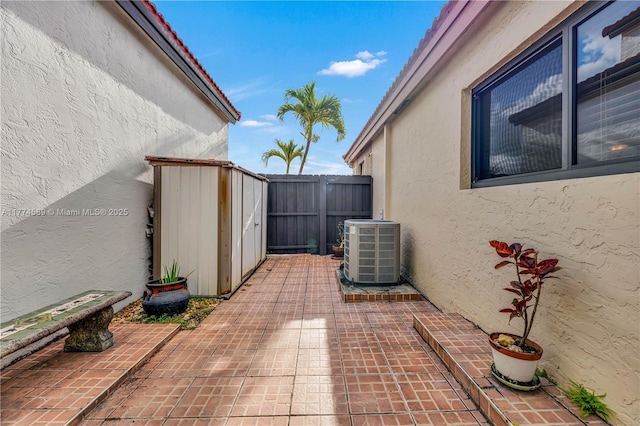 8914 SW 5th Ln, Miami, FL 33174 - view of patio with an outbuilding, fence, central AC, and a shed