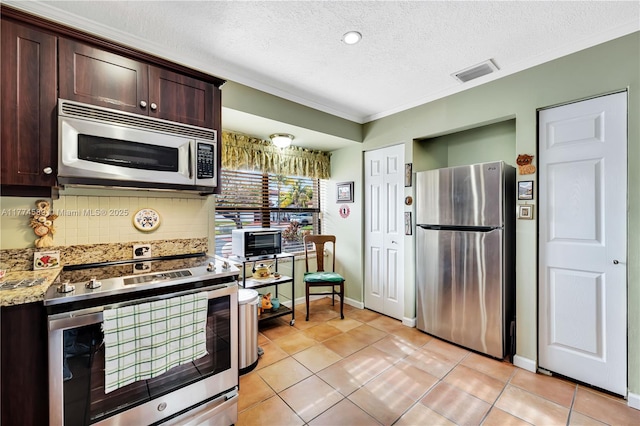 8914 SW 5th Ln, Miami, FL 33174 - kitchen featuring decorative backsplash, a textured ceiling, visible vents, dark brown cabinetry, and appliances with stainless steel finishes