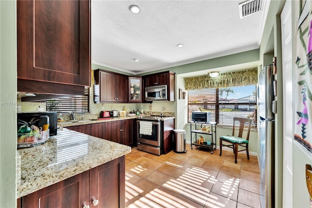 8914 SW 5th Ln, Miami, FL 33174 - kitchen with stainless steel appliances, a textured ceiling, light stone counters, and visible vents