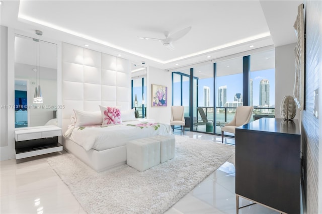 5000 Island Estates Dr Unit 704, Aventura, FL 33160 - bedroom featuring a tray ceiling, access to exterior, floor to ceiling windows, and a view of city