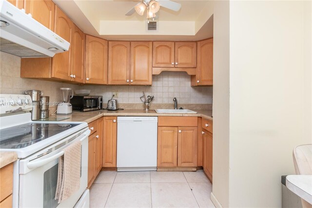 2780 NE 183rd St Unit 1606, Aventura, FL 33160 - kitchen with white appliances, light tile patterned floors, under cabinet range hood, a sink, and visible vents