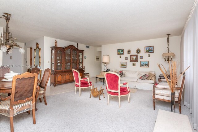 2780 NE 183rd St Unit 1606, Aventura, FL 33160 - carpeted living area featuring visible vents, an inviting chandelier, and a textured ceiling