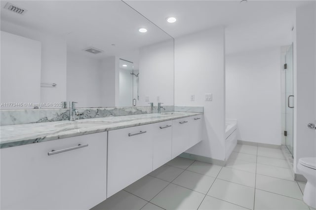 55 SE 6th St Unit 3503, Miami, FL 33131 - bathroom with double vanity, a bath, a stall shower, recessed lighting, and baseboards