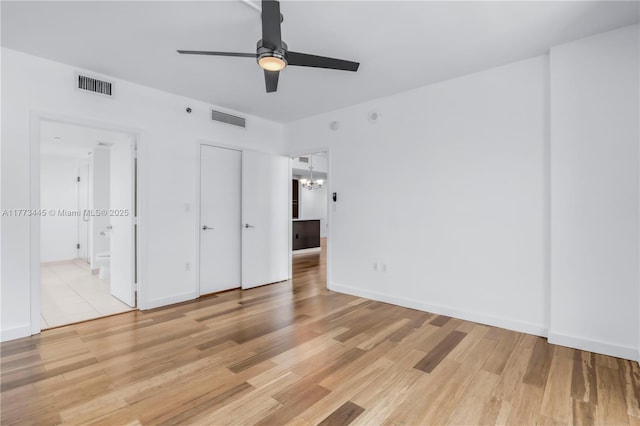 55 SE 6th St Unit 3503, Miami, FL 33131 - unfurnished bedroom with light wood finished floors, a chandelier, baseboards, and ensuite bath