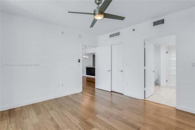 55 SE 6th St Unit 3503, Miami, FL 33131 - unfurnished bedroom with light wood finished floors, ensuite bath, a closet, and a ceiling fan