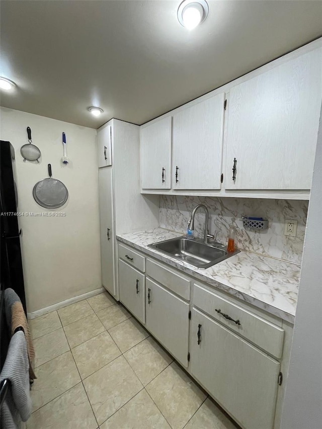 230 SW 11th Ave Unit 15, Hallandale Beach, FL 33009 - kitchen with a sink, light countertops, light tile patterned floors, tasteful backsplash, and white cabinetry