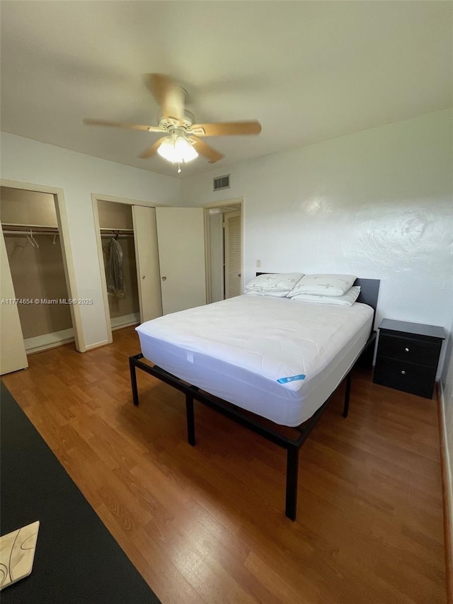 230 SW 11th Ave Unit 15, Hallandale Beach, FL 33009 - bedroom with multiple closets, light wood-style flooring, ceiling fan, and baseboards