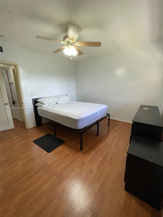 230 SW 11th Ave Unit 15, Hallandale Beach, FL 33009 - bedroom with light wood-style flooring, baseboards, and ceiling fan