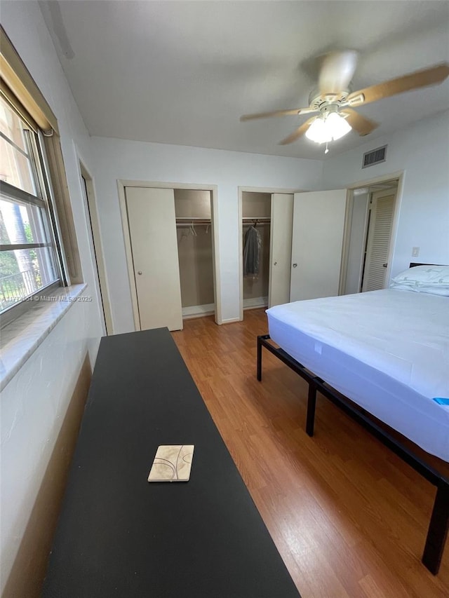230 SW 11th Ave Unit 15, Hallandale Beach, FL 33009 - bedroom with multiple closets, wood finished floors, and a ceiling fan