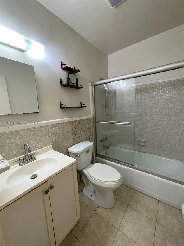 230 SW 11th Ave Unit 15, Hallandale Beach, FL 33009 - full bath with tile patterned floors, vanity, toilet, enclosed tub / shower combo, and tile walls
