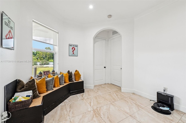 interior space with baseboards and arched walkways