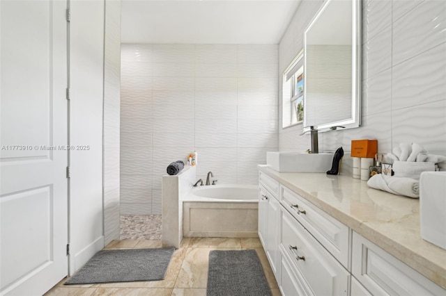 full bathroom featuring tile walls, a bath, vanity, and walk in shower
