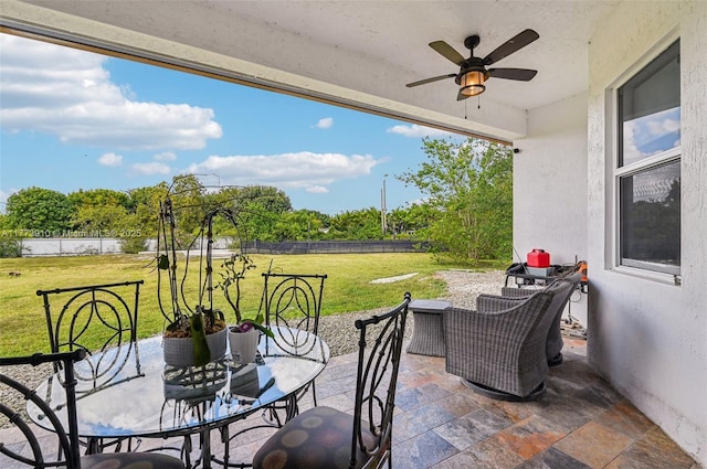 view of patio with outdoor dining area, a fenced backyard, and ceiling fan