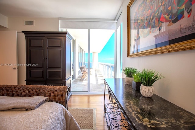 1850 S Ocean Dr Unit 1004, Hallandale Beach, FL 33009 - bedroom featuring access to outside, floor to ceiling windows, visible vents, and light wood-style flooring