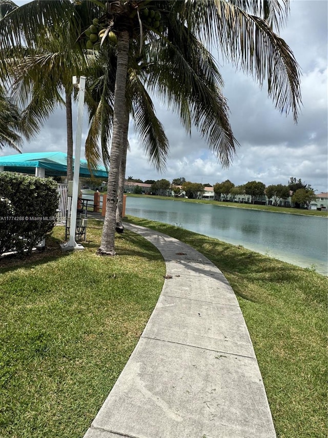 exterior space with a water view and a yard