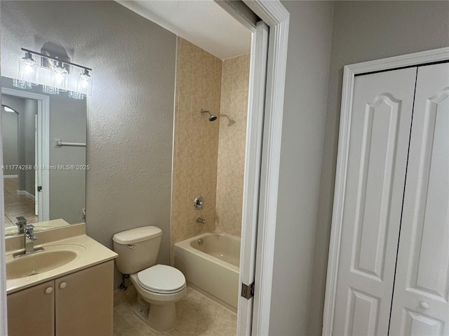 full bathroom featuring toilet, vanity, shower / bathtub combination, tile patterned flooring, and a textured wall