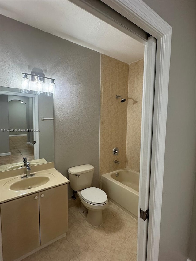 full bathroom with shower / washtub combination, a textured wall, toilet, and vanity