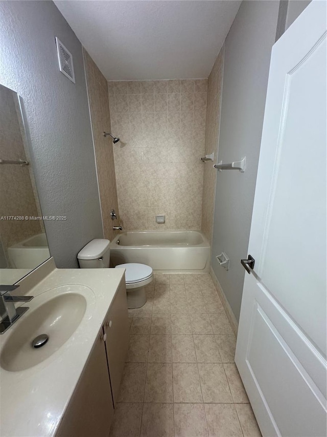 full bathroom with visible vents, baseboards, toilet, vanity, and tile patterned flooring