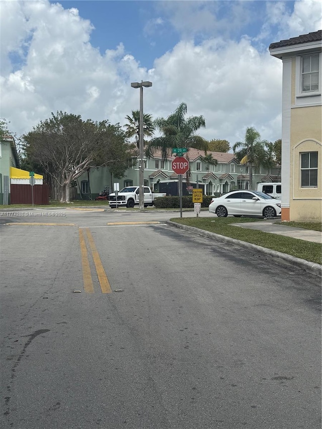 view of street featuring traffic signs and curbs