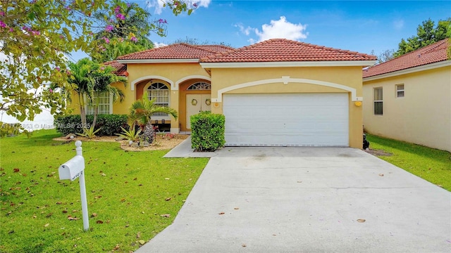 mediterranean / spanish house featuring a tiled roof, a garage, stucco siding, a front lawn, and driveway