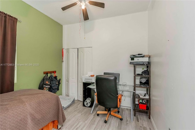 bedroom with a closet, ceiling fan, and wood finished floors