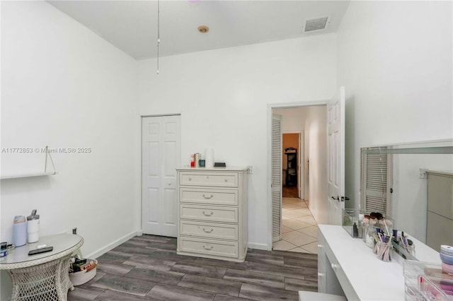 interior space with wood finished floors, baseboards, and visible vents