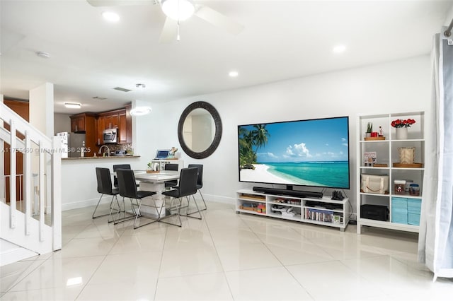 living area featuring baseboards, recessed lighting, light tile patterned floors, stairs, and ceiling fan