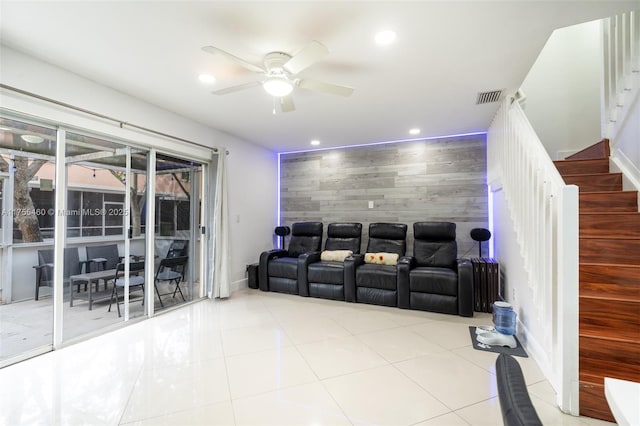 tiled cinema room featuring visible vents, baseboards, an accent wall, a ceiling fan, and recessed lighting